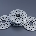 Multiple Perforated Circular Washers Stacked With Central Holes And Textured Surface