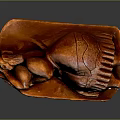 Wooden Sculpture Carving Of Curled Brown Figure With Detailed Texture Displayed On Dark Surface