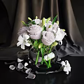 Transparent Glass Vase With Purple Roses White Lilies And Scattered Petals On Dark Background