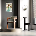 Indoor Corner Design With Gray Wall Beige Chair Wooden Frame Black Table And Artwork