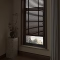 Wooden Window Blinds In Interior With Decorative Vase On Marble Pedestal
