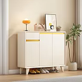 Stylish White Shoe Cabinet with Yellow Trim and Decorative Items Near Potted Plant