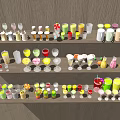 Colorful Assorted Beverages Displayed On Multiple Shelves With Various Glassware And Bottles