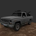 Gray Pickup Truck With Roof Equipment And Weapon In Bed On Dirt Ground