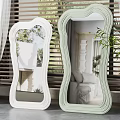 Stylish Curved Frame Mirrors In White And Light Green With Reflected Room Interior And Plants