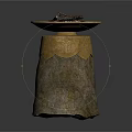 Stone Pedestal With Brass Bowl Filled With Black Charcoal Pieces And Ornate Gold Carvings On Base