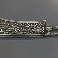 Ornate Decorative Metal Weapon with Intricate Carved Patterns on Blade and Handle