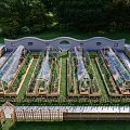 Serene Garden Landscape with Transparent Arched Greenhouses Wooden Frames Planter Boxes and Colorful Flowers