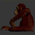 Realistic Red Orangutan Statue Sitting With Detailed Textured Surface On Gray Background