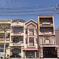 Row of Terraced Townhouses with Colorful Facades Balconies and Urban Street View