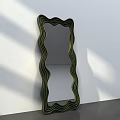 Wavy Frame Mirror With Green And Black Stripes Against White Wall And Gray Floor