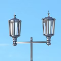 Two Stylish Outdoor Lights Mounted On Metal Pole Against Blue Sky