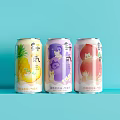 Refreshing Canned Drinks With Pineapple Grape Peach Flavors On Light Blue Background