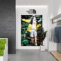 The North Face Clothing Store with Hanging Apparel Poster Display and Green Plants
