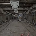 Industrial Tunnel Interior With Rail Tracks Metal Pipes And Concrete Floor