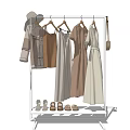 Minimalist Clothes Rack Displaying Hanging Neutral Toned Dresses Tops Pants And Shoes