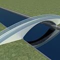 Modern Curved Bridge With Glass Railing Over Waterway And Green Grass