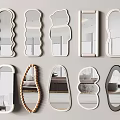 Various Shaped Decorative Mirrors Arranged on Light Colored Wall 3d model