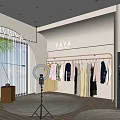 Modern Public Office Space with YAYA Logo Clothes on Hangers Ring Light and Green Plants