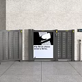 Grey Turnstiles Featuring Central Advertising Screen With Fly First Class Ad And Control Panel