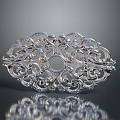 Silver Decorative Piece with Intricate Filigree Carvings and Ornate Scrollwork