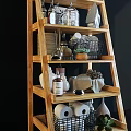 Multi Tiered Wooden Shelf Unit With Potted Plants Baskets Glass Bottles And Decorative Items