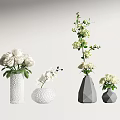 White Flowers In Textured And Geometric Vases Featuring Roses Orchid And Small Blooms