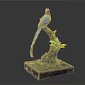 Blue Bird Sculpture Perched On Green Branch With Green Leaves And Blue Base