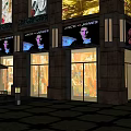 Urban Modern Commercial Complex With Illuminated Storefronts Pedestrian Walkways And Retail Shops