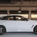 White Sleek Sporty SUV Parked In Interior Garage With Roller Doors And Black Alloy Wheels