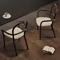 Single Chair With Black Frame Beige Cushion Dark Wooden Floor Coffee Cup And Open Book