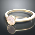 Elegant Gold Ring With Oval Pink Gemstone And Polished Band Design