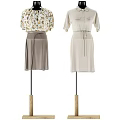 Clothes Hanger Displaying Floral Blouse Gray Skirt And Beige Dress With Waist Tie