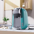 Teal Coffee Maker Kitchen Appliance On Modern Marble Countertop With Cabinets And Window Plant
