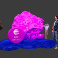 People Interacting With Pink Installation And IBC Amsterdam Logo On Blue Carpet