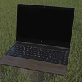 Modern Laptop With Black Screen Black Keyboard And Wooden Palm Rest On Grass
