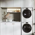 Modern Home Balcony Featuring White Cabinets Stacked Washer Dryer Black Doors Window and City View
