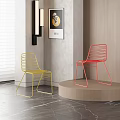 Modern Yellow And Red Metal Wire Dining Chairs On Pedestal With Gray Wall