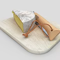 Artisanal Cheese Wedge On Wooden Cutting Board With Leather String Knife