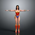 Woman in Wonder Woman Costume with Red and Blue Outfit Arms Outstretched Against Gray Background Golden Accessories and Boots