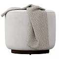 Light Gray Upholstered Round Ottoman With Knitted Plaid Blanket And Dark Wooden Base