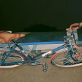 Blue Bicycle with Orange Seat Red Rims and Stylish Urban Design Features
