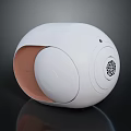 White Spherical Electronic Device With Brown Accent Round Button And Speaker Grill