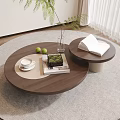 Round Wooden Coffee Table On Gray Rug With Open Book Green Plant Teacup And Books