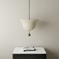 White Bell Shaped Pendant Light With Green Ball Above White Table And Books