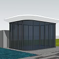 Modern Entrance Gate With Glass Structure Lush Green Trees And Paved Pathway