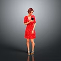 Standing In Red Polka Dot Dress Holding Black Cup Against Gray Background With Beige Shoes