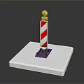 Red And White Striped Marker Pole With Yellow Top On White Base And Black Bottom