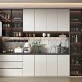 Modern Wine Cabinet With White Cabinets Marble Countertop Wine Bottles Glassware And Green Plants