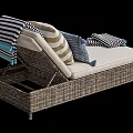 Wicker Lounge Chair with Beige Cushion Striped Pillows and Blue Throw Blanket